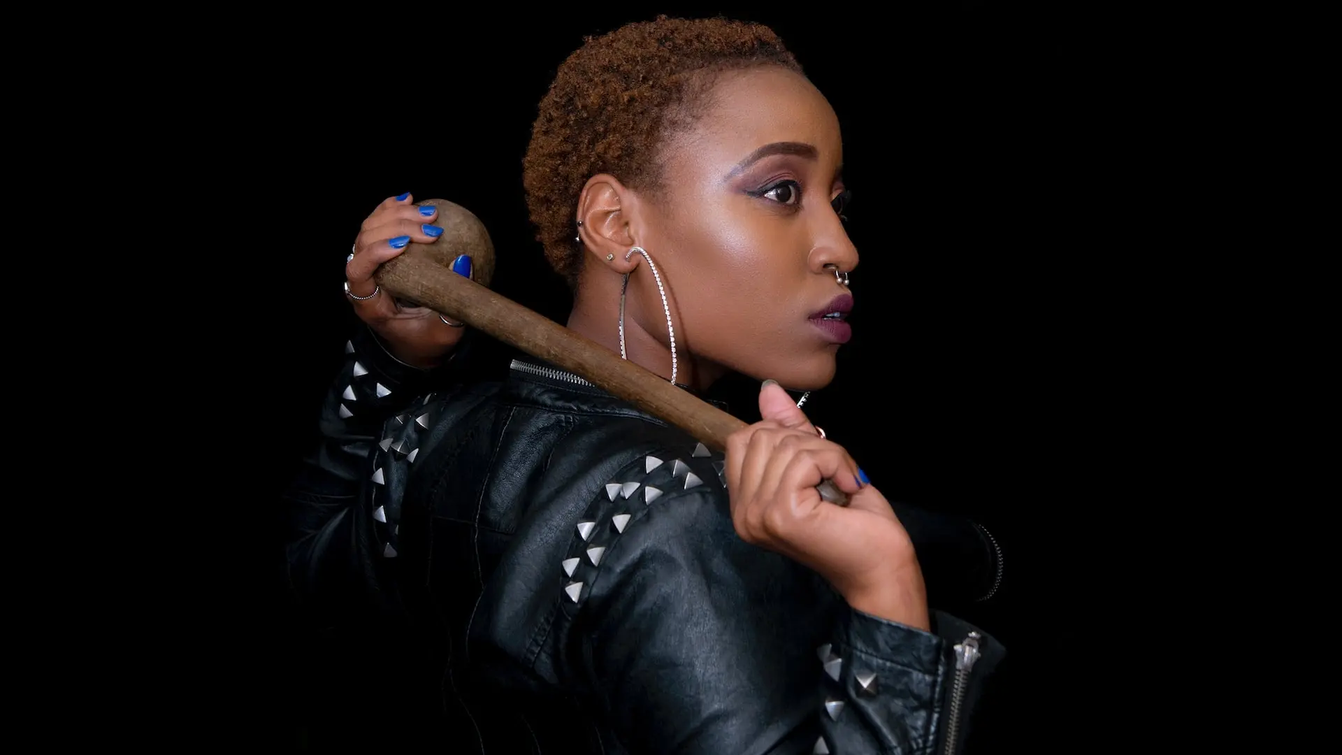 woman posing with brown hand tool